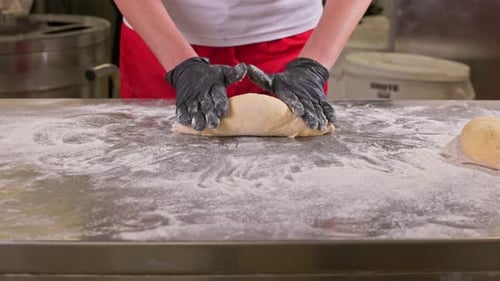 Professional Chef Prepares Dough with Black Gloves