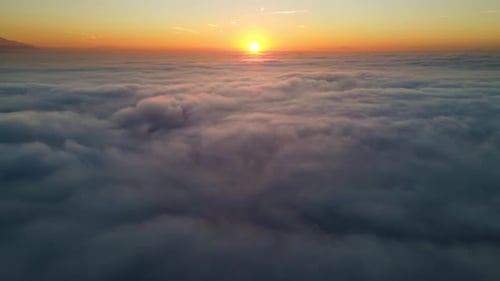Aerial View of Clouds at Golden Sunrise