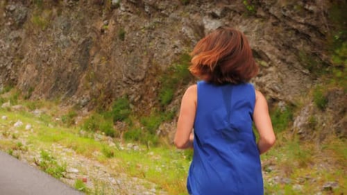 Woman Jogging on Rural Road in Daylight
