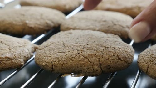 Picking bread product from baking grill 4K 2160p 30fps UltraHD footage - Close-up female picks h