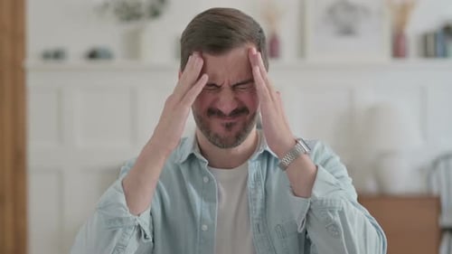 Portrait of Tired Young Man Having Headache