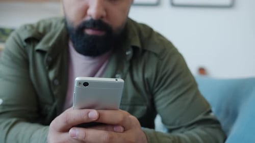 Man Using Smartphone Indoors