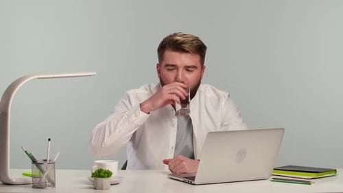 Young Business Men with Indignation and Anger are Typing on the Laptop While Sitting at the Table in