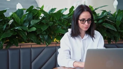 Woman Working on Laptop in Modern Office Space