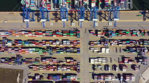 Container ship in export and import business and logistics. Shipping cargo to harbor by crane. Water