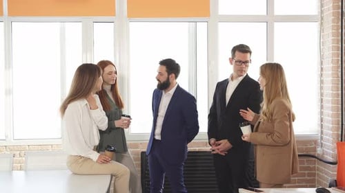 Business Professionals Chatting Casually in Modern Office