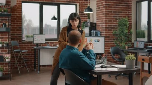 Business Colleagues Discussing Data Charts in Modern Office