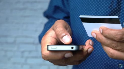 Man Hand Holding Credit Card and Using Smart Phone Shopping Online