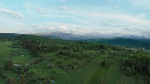 Aerial View of a Mountain Landscape with Rocky Peaks on the Background