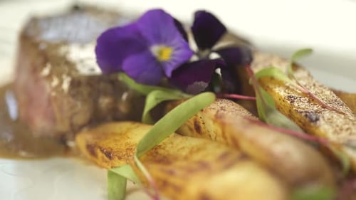 Gourmet Steak with Roasted Potatoes and Edible Flowers