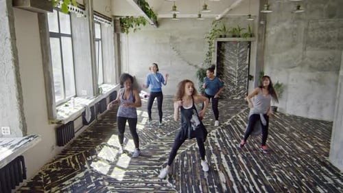 Women Doing Cardio Dance in Fitness Studio