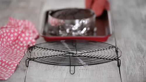 Freshly baked chocolate sponge cake on cooling rack.