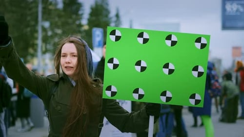Woman Protesting with Chroma Key Sign on City Street