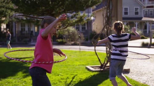 Girls playing with hula hoops at park
