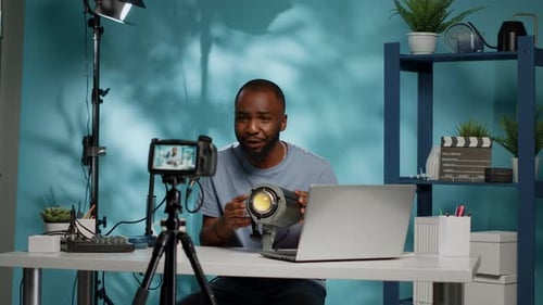 African American Blogger Reviewing Studio Light on Camera