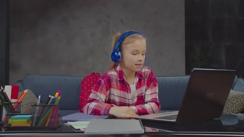 Child Studying Online with Laptop and Headphones