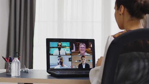 Woman Attends Virtual Meeting on Laptop Computer