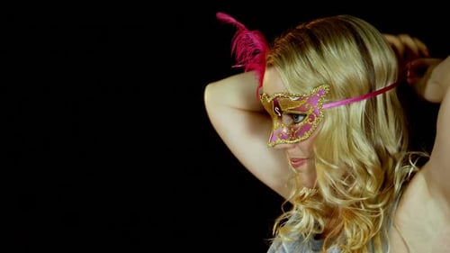 Woman wearing masquerade mask on stage