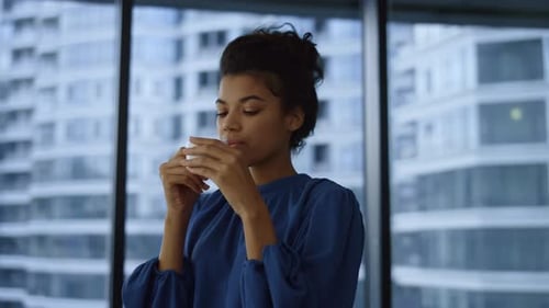 Relaxed Businesswoman Drinking Coffee Cup in Office