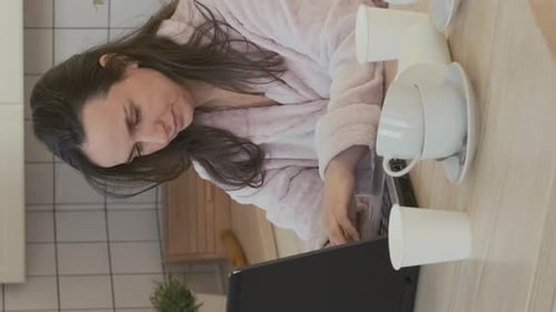 Exhausted Woman Works at Home with Laptop