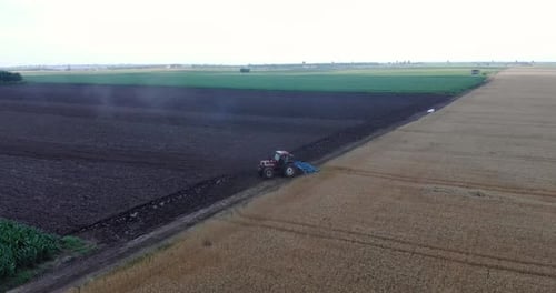 Tractor Tilling Soil Between Fields, Aerial View