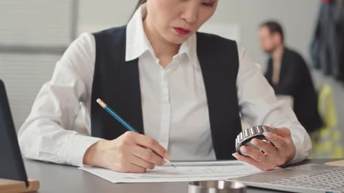 Female Asian Technology Construction Engineer Working in Office