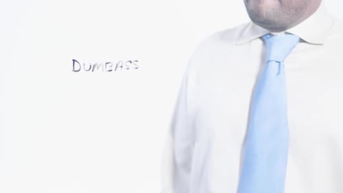 Person Writes the Word Dumbass on Clear Surface