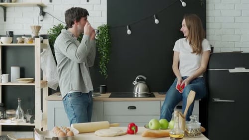 Romántica pareja joven cocinando juntos en la cocina pasando un buen rato juntos