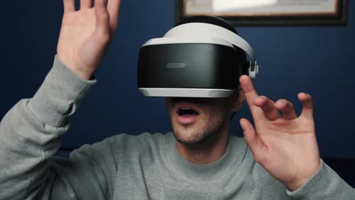 Young Adult Interacts with Virtual Reality Headset