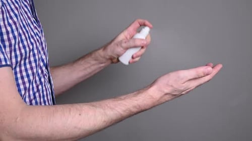 Man Applies Hand Sanitizer to Clean His Hands