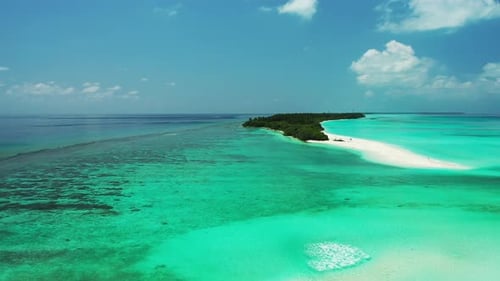 Daytime above island view of a paradise sunny white sand beach and aqua blue water background
