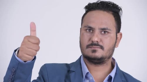 Smiling Businessman Gives Thumbs Up Gesture