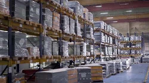 Large Warehouse with the Company's Products. Tall Steel Racks with Finished Products Await Shipment