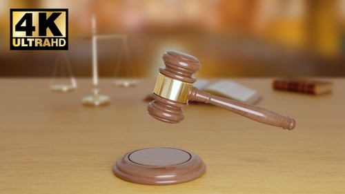 Wooden Gavel on Table in Courtroom Setting