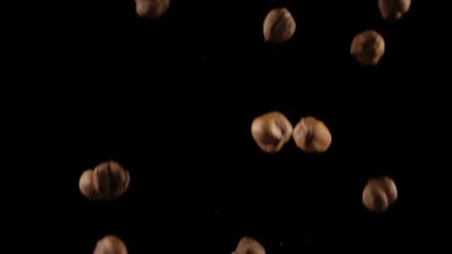 Hazelnuts Falling in Slow Motion on Black Background