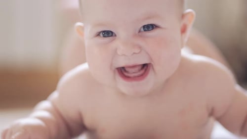 Happy Baby Crawling and Smiling at Camera