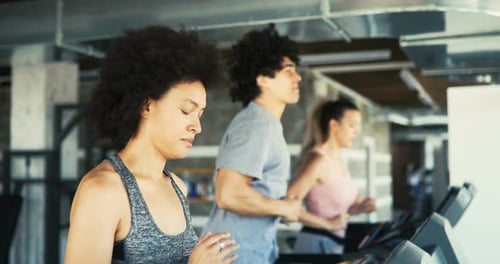 Group of Young People Running on Treadmills in Sport Gym
