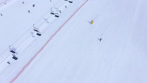 Ski Slope Ski Lift Skiers and Snowboarders Going Down