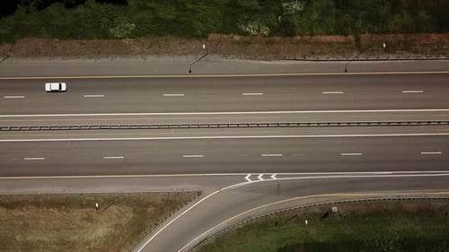 Top Down Close Up of Road, Asphalt, White Arrow Signs Indicating Direction, Way of the Highway