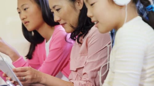 Family Using Technology Devices Together Indoors