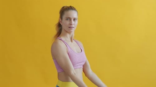 Slender Young Woman Wearing Trendy Sportswear Exercising with Dumbbells