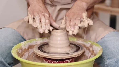 Couple Hands Making a Pot on a Pottery Workshop