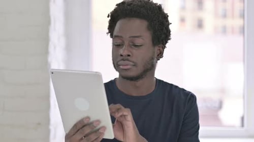 Portrait of Ambitious Young African American Man Using Tablet in Office