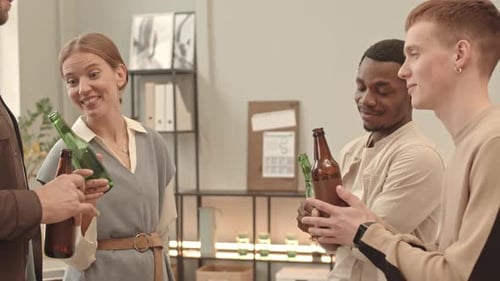 Coworkers Drinking Beer in Office