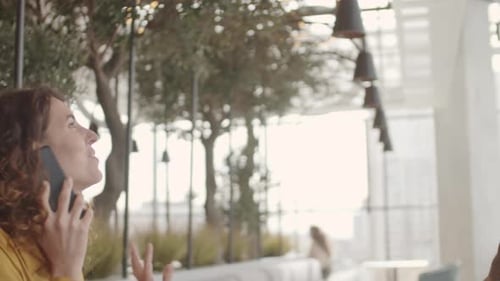 Two Pretty Women Having Meeting in Cafe