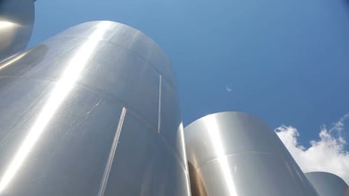 Low Angle View of Gleaming Silver Storage Tanks