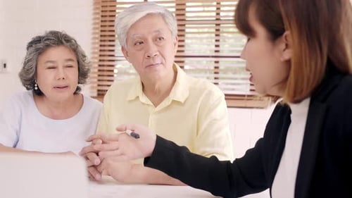 Financial Advisor Meeting with Mature Couple at Home