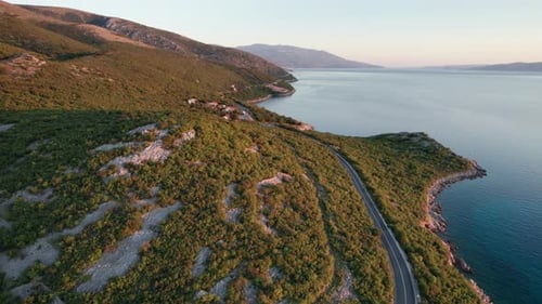 Aerial View Landscape Rocky Coast of Croatia with Curvy Mountain Road at Sunset