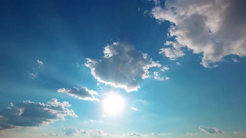 Brilliant Sun Shining Through Clouds in Blue Sky