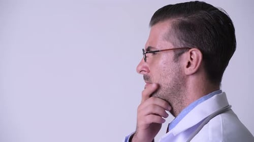 Profile View of Young Hispanic Man Doctor Thinking